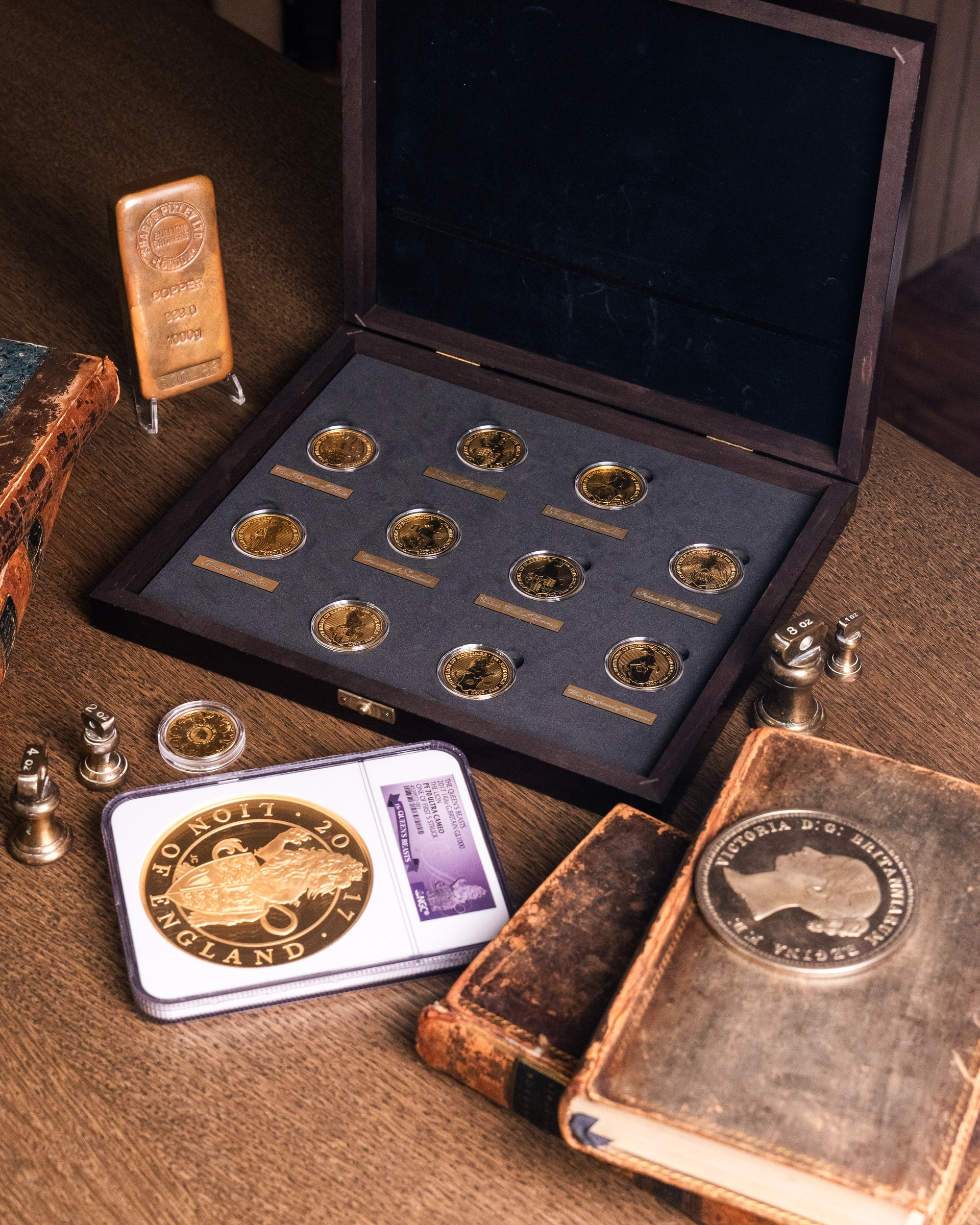 Gold coin collection in an open presentation box with bullion and collectible coins